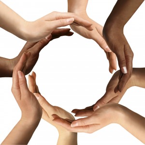 6 people's hands making the shape of a circle